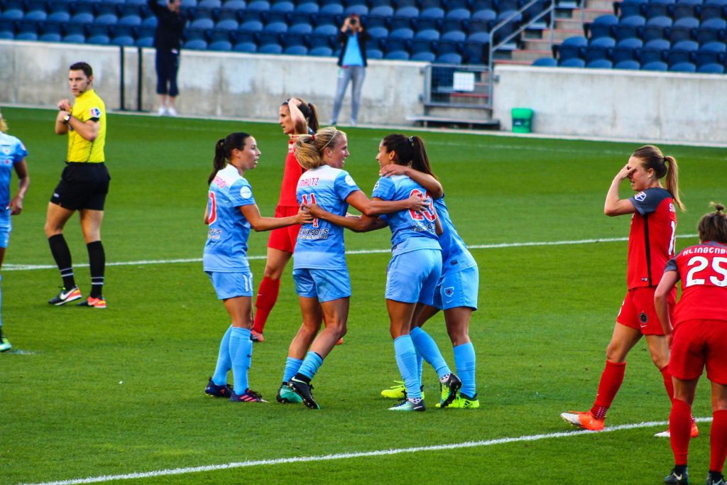 women's football team making sure they staty safe during a game of football 