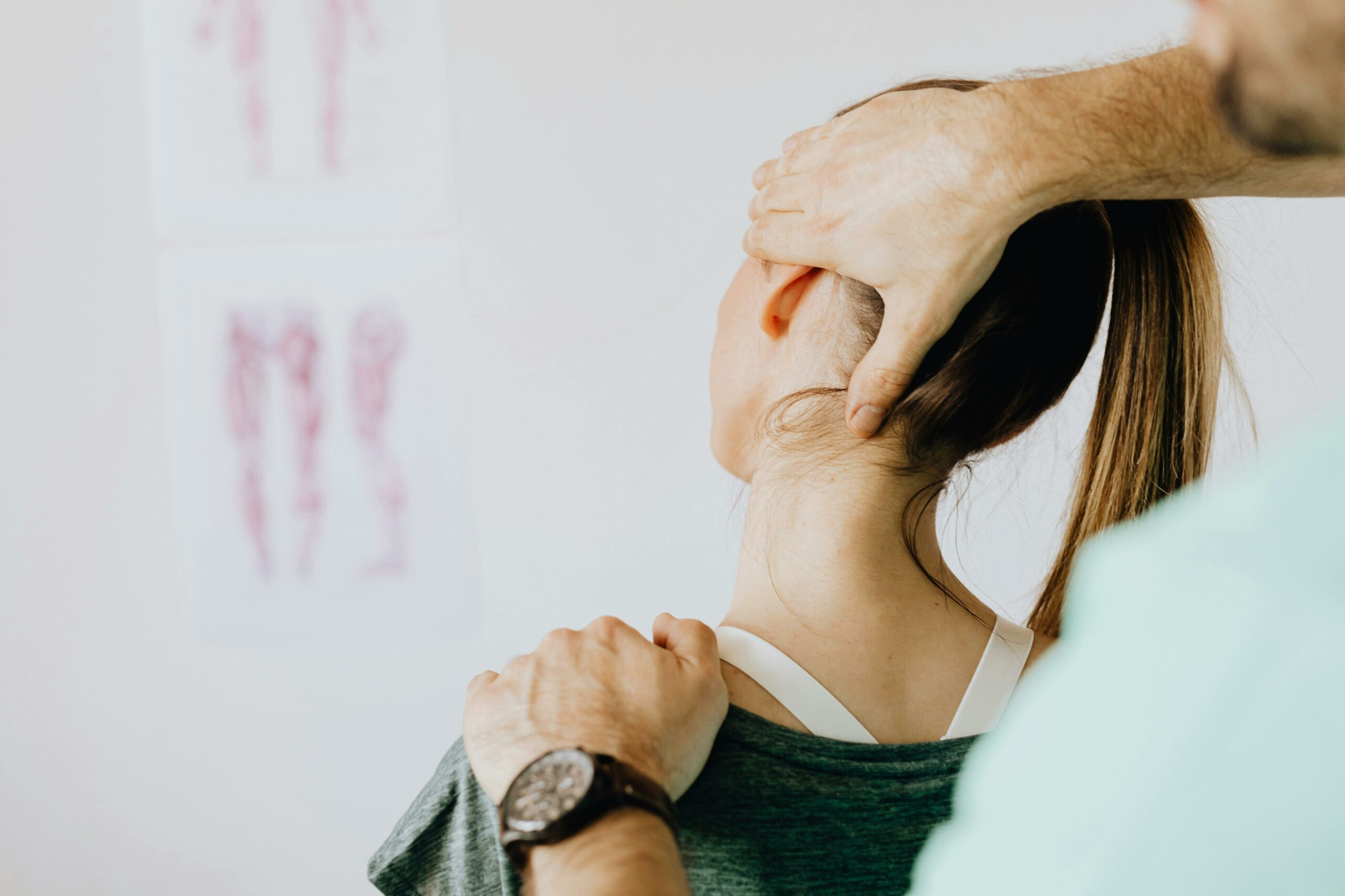 a woman seeing a physiotherapist for a neck injury sustained after slipping over in the workplace