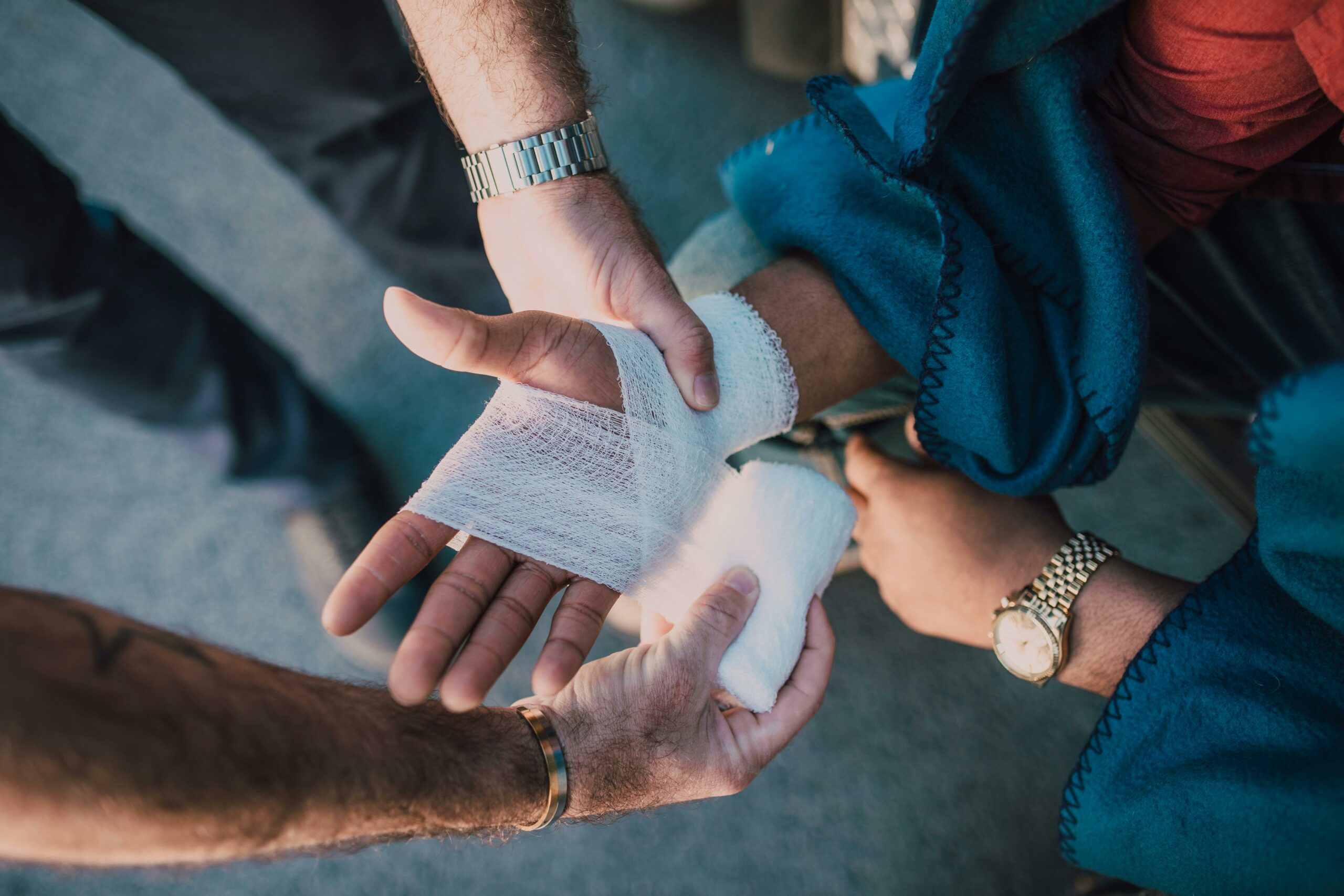 a bandage being applied to a person's wrist after tripping over at work
