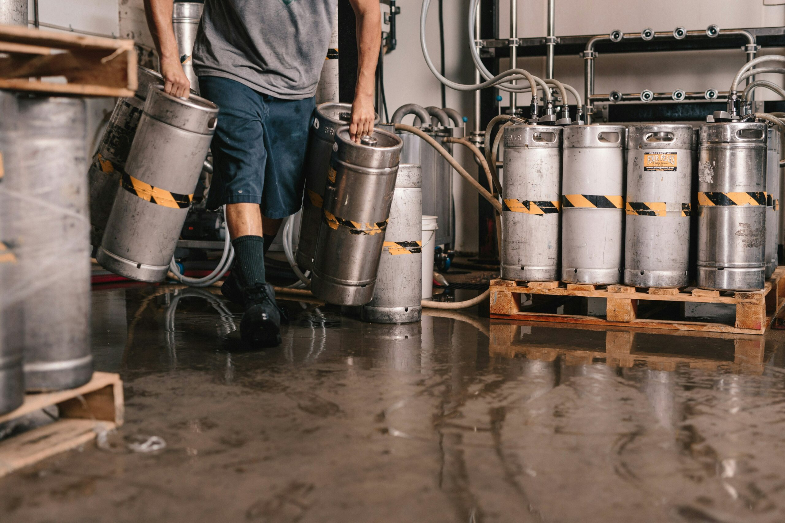 a man carrying kegs containing flammable liquids in a manufacturing plant determining what could trigger a coshh risk assessment review
